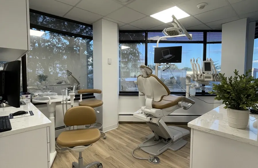 A treatment room with a dental chair beside the windows, at the Seaview Boulevard office.